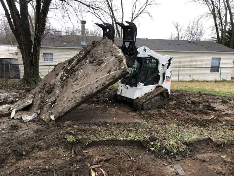 Delta-X removing a concrete pad at a trailer park.