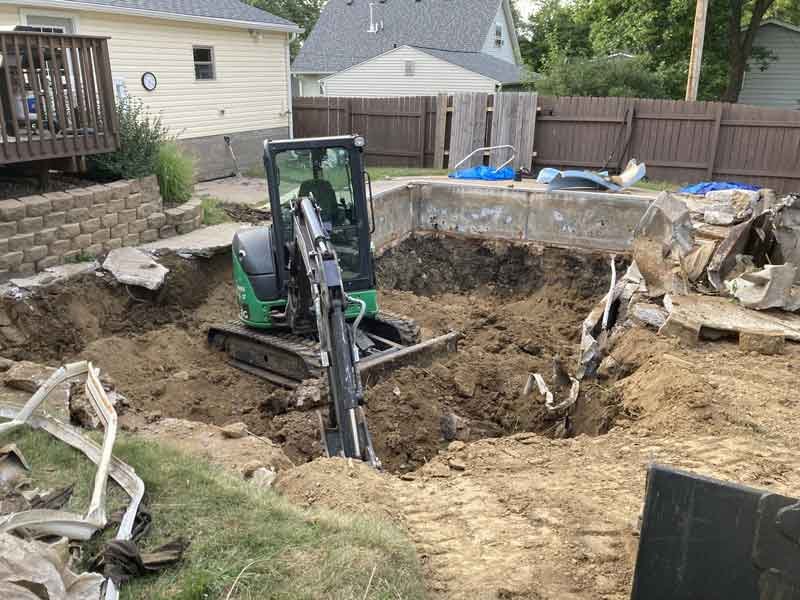 Delta-X LLC removing an inground pool with an excavator in the Quad Cities - Davenport, Iowa.